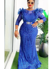 A woman wears a royal blue sequined mermaid-style evening gown with ruffled shoulders and a belt.