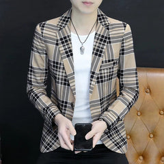 A man wears a slim-fit, single-breasted blazer featuring a tan and black plaid pattern.