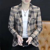 A man wears a slim-fit, single-breasted blazer featuring a tan and black plaid pattern.