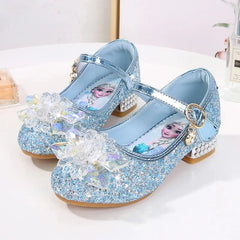 A pair of sparkly blue Elsa-themed princess shoes with crystal flower accents and low heels.