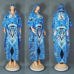A blue and white tie-dye hooded kaftan dress with a loose, flowing silhouette.