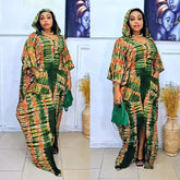 A woman wears a green and orange patterned hooded maxi kaftan dress with side pockets.