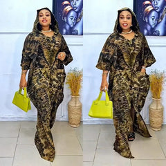 A woman wears a hooded, long-sleeved maxi dress featuring a brown and black tie-dye pattern.