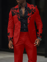 A man wears a red slim-fit suit jacket featuring black geometric patchwork patterns on the lapels and sleeves.