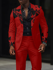 A man wears a red slim-fit suit jacket featuring black geometric patchwork patterns on the lapels and sleeves.