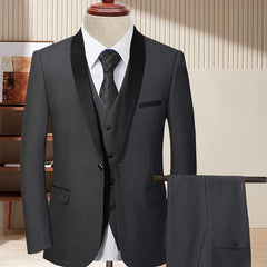 A charcoal grey three-piece suit featuring a shawl collar jacket, vest, and matching trousers.