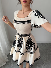 Elegant Mini Dress with a Square Neckline, Featuring Fashionable Prints, Pleats, a Cinched Waist for a Slimming Effect, And Ruffled Edges with an A-Line Hem.