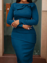 A solid teal long-sleeve bodycon dress featuring a crew neckline with bow detail.