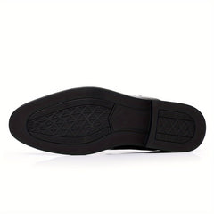 The underside of a black men's business casual loafer featuring a textured rubber sole.