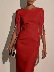 A red midi bodycon dress with a crew neck and half sleeves featuring pearl-trimmed side slits.