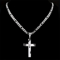 A silver-toned layered cross pendant hangs from a matching curb chain against a black background.