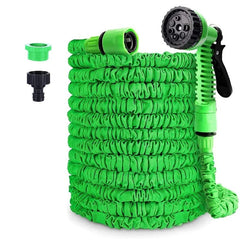 A coiled green expandable garden hose with a multi-pattern spray nozzle and two faucet adapters.