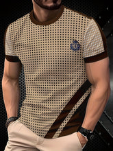 A men's beige crew neck t-shirt featuring a black polka dot pattern and brown contrast accents.