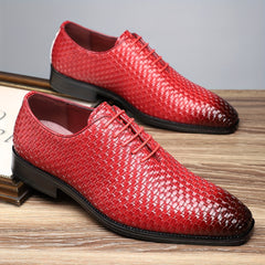 A pair of red woven-texture men's Oxford shoes with black rubber soles and lace-up closures.