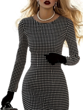 A woman wears a fitted, long-sleeve black and white houndstooth dress with a crew neckline.