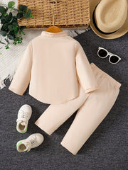 A beige long-sleeved shirt with a stand collar and matching pants for baby boys.
