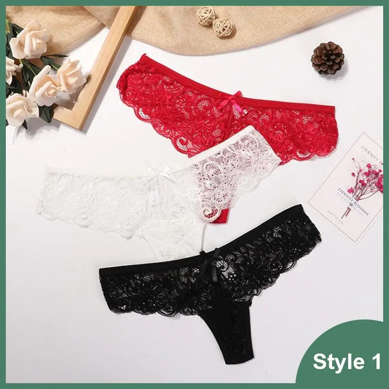 Three 3 Pcs Woman Panties Sexy Lace Thong Underwear are shown in red, white, and black on a white surface with flowers, a pine cone, twine balls. "Style 1" appears at the bottom right.