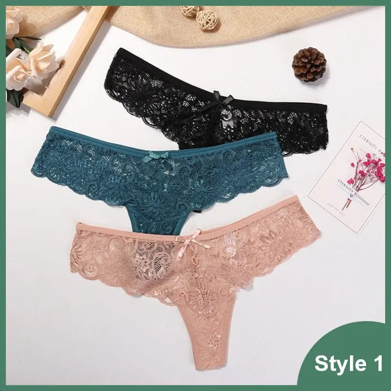 Three Sexy Lace Thong Underwear from the 3 Pcs Woman Panties set in black, teal, and beige are displayed on a white surface with decor; "Style 1" is noted in the corner. These low waist T-back G-strings offer a tempting transparent design.