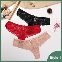 Three pairs of 3 Pcs Woman Panties Sexy Lace Thong Underwear—black, red, and beige—are shown on a white surface with roses, a pine cone, and a floral card. The bottom right corner is labeled Style 1.