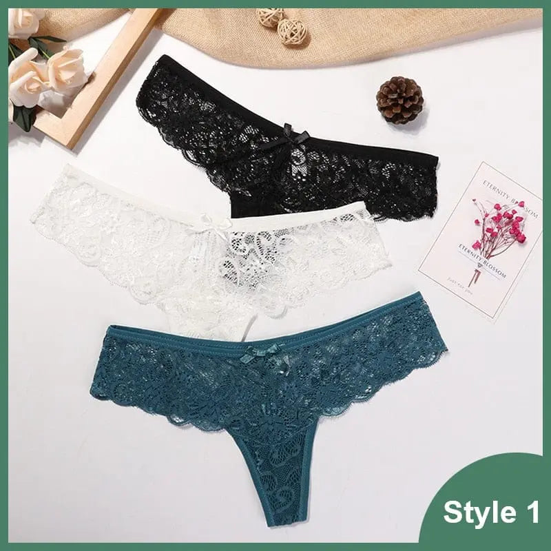 Three pairs of Style 1 low waist lace G-string panties in black, white, and teal are shown on a white background with flowers, a pinecone, and a card. Product: 3 Pcs Woman Panties Sexy Lace Thong Underwear Female T-back Transparent G String.