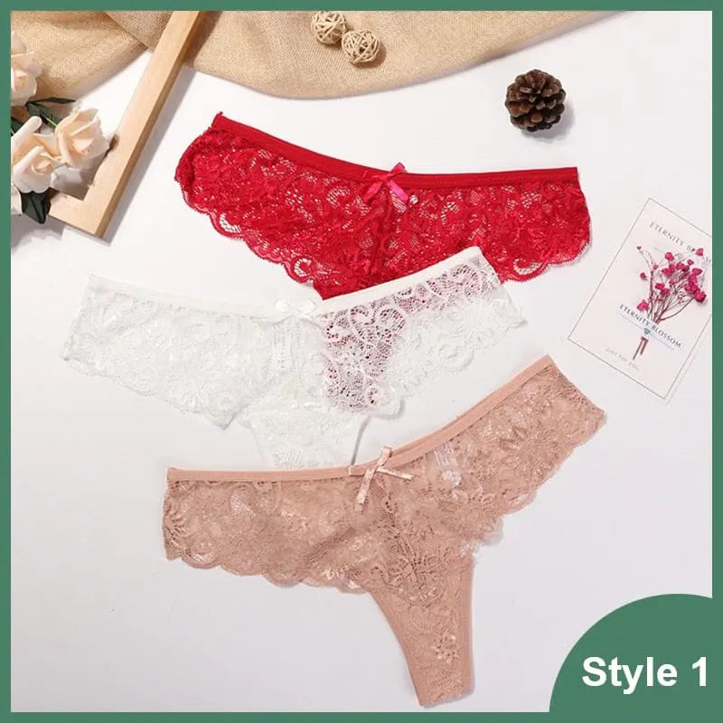 Three 3 Pcs Woman Panties Sexy Lace Thong Underwear—red, white, and nude—are displayed on a white surface with decorative flowers, a card, beige cloth, and “Style 1” in the lower right corner.