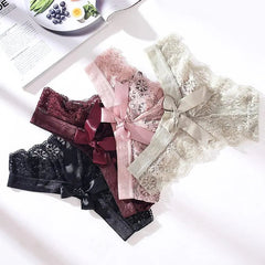 Three 3 Pcs Woman Panties Sexy Lace Thong Underwear in black, burgundy, and light beige with satin bows are arranged overlapping on a white surface next to an open magazine.