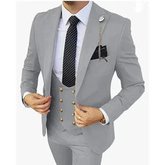 A man wears a slim-fit light gray three-piece suit with a black polka-dot tie and gold buttons.