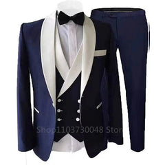 A navy blue three-piece slim fit tuxedo featuring a white shawl lapel, vest, and matching trousers.