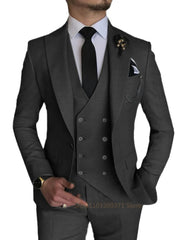 A man wearing a three-piece light gray suit with a double-breasted vest and a black tie.