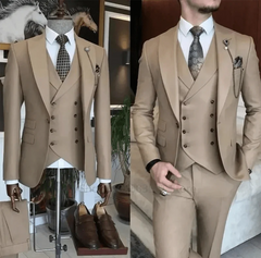 A slim-fit khaki three-piece suit featuring a double-breasted vest and a patterned tie.