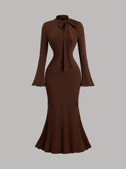 A solid brown long-sleeve mermaid dress featuring a high collar with a bow tie detail.