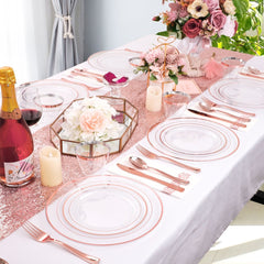A rose gold disposable dinnerware set arranged on a table with plates, cutlery, cups, and napkins.