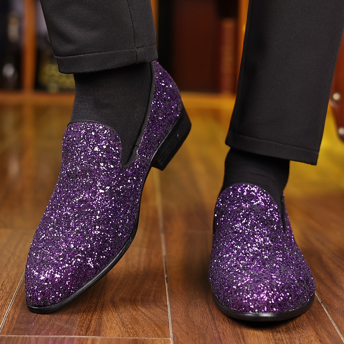 A pair of men's purple glitter slip-on dress shoes with a pointed toe and black rubber sole.