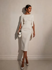 A woman wears a white midi-length bodycon dress with half sleeves featuring pearl button details.