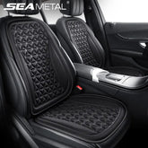 A black 3D breathable car seat cushion with a geometric pattern installed on a vehicle seat.