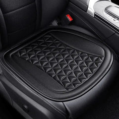 A black, breathable car seat cushion with a 3D quilted pattern installed on a vehicle seat.