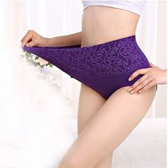 A person wears high-waisted purple cotton briefs with a decorative floral pattern.