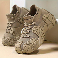 A pair of beige high-top sneakers with a textured knit upper and a unique geometric sole design.