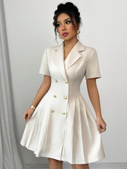 A light beige, short-sleeved, double-breasted A-line dress with a lapel collar and button details.