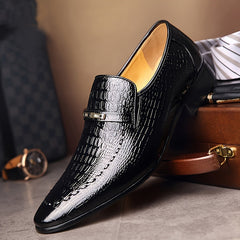 Black crocodile-embossed men's slip-on loafers with a gold-tone metallic emblem.