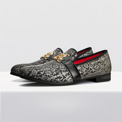 Black and silver floral pattern loafers featuring a gold buckle and a red interior lining.