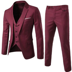 A slim-fit burgundy three-piece suit featuring a blazer, vest, and matching trousers.