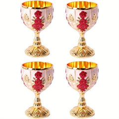 A set of four small, gold-toned metal goblets featuring embossed red rose and leaf designs.