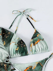 A green and black marble print bikini top with gold accents and halter neck ties.