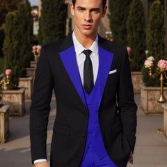 A man wears a black suit jacket with blue lapels, a blue vest, and matching blue trousers.