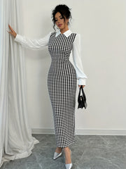 A woman wears a black and white houndstooth bodycon dress with a white collared shirt bodice.