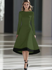 A woman wears an olive green long-sleeve midi dress with a black hem and a cinched waist.