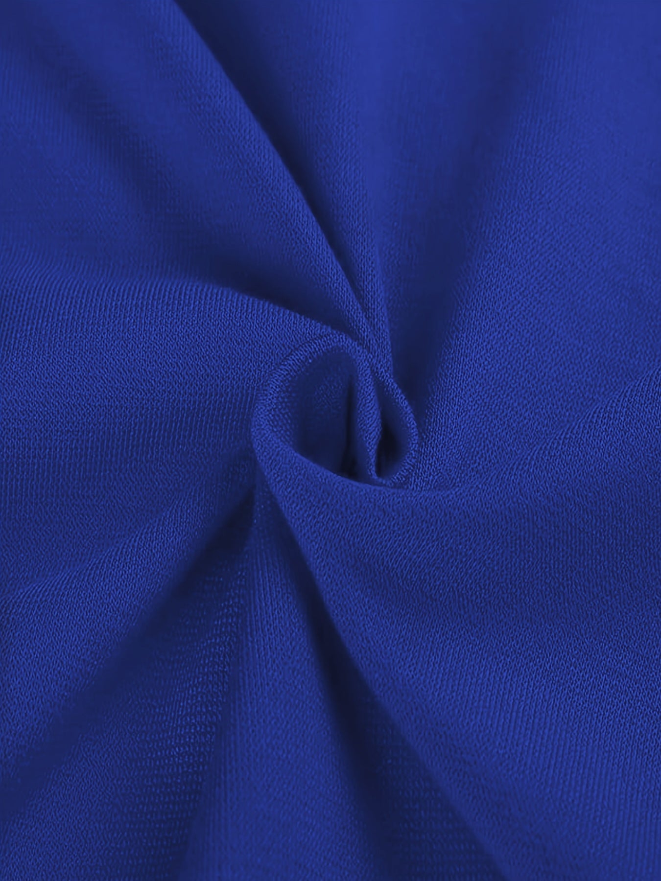 A close-up view of royal blue knit fabric with a subtle texture and soft folds.