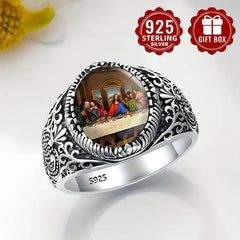 A vintage sterling silver ring featuring an engraved band and a round Last Supper image.