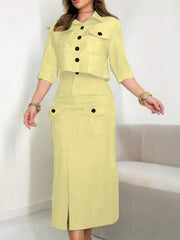A woman wears a light yellow two-piece set featuring a button-down shirt and a matching midi skirt.
